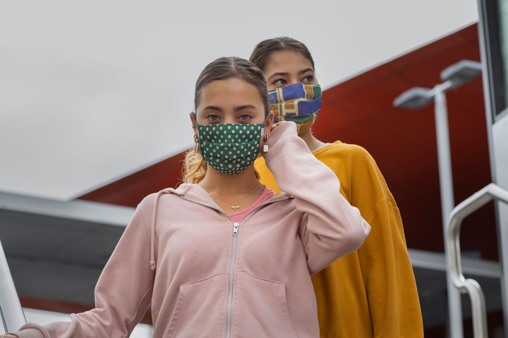 boy in orange zip up hoodie wearing mask