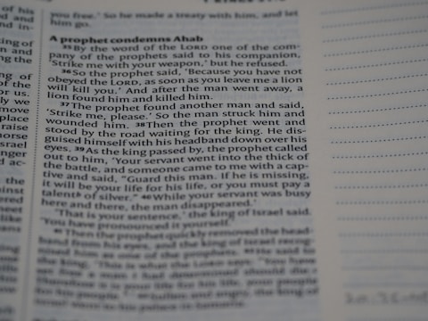 A close-up view of a page from a book, featuring the beginning of a passage focused on a prophet condemning Ahab. The text is printed in black on a cream-colored page with a header and lines for notes on the right. The text is slightly out of focus at the edges.