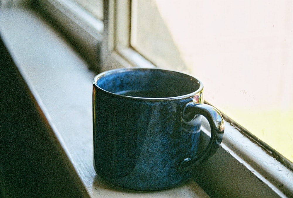 blue ceramic mug on white table