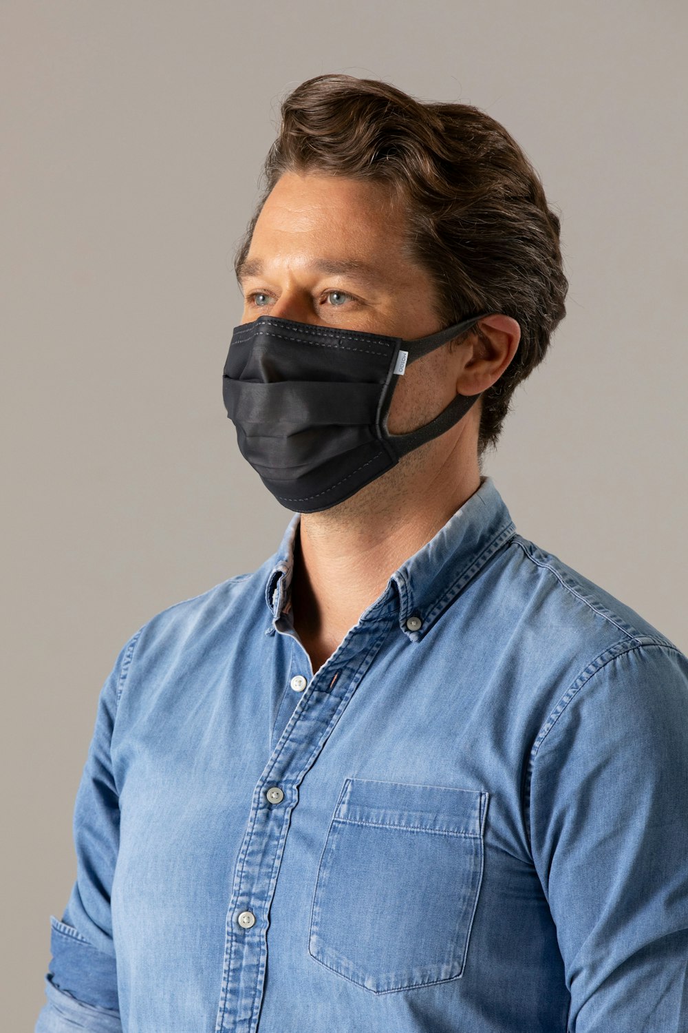 man in blue denim button up shirt wearing black goggles