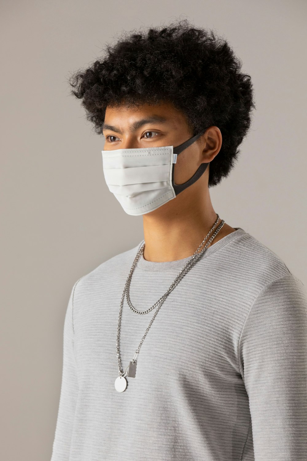 man in white turtleneck sweater wearing white face mask