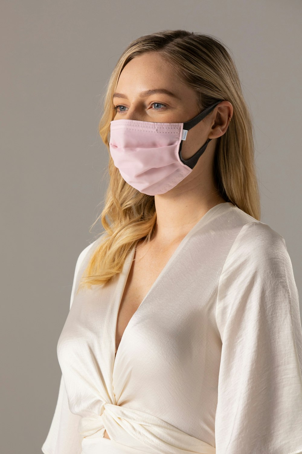 woman in white long sleeve shirt wearing white mask