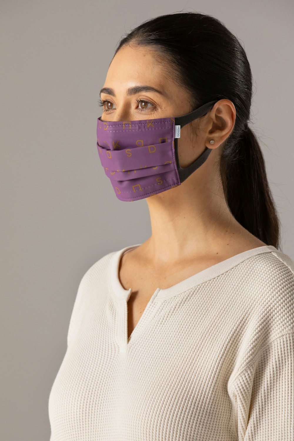 woman in white shirt wearing purple eye mask
