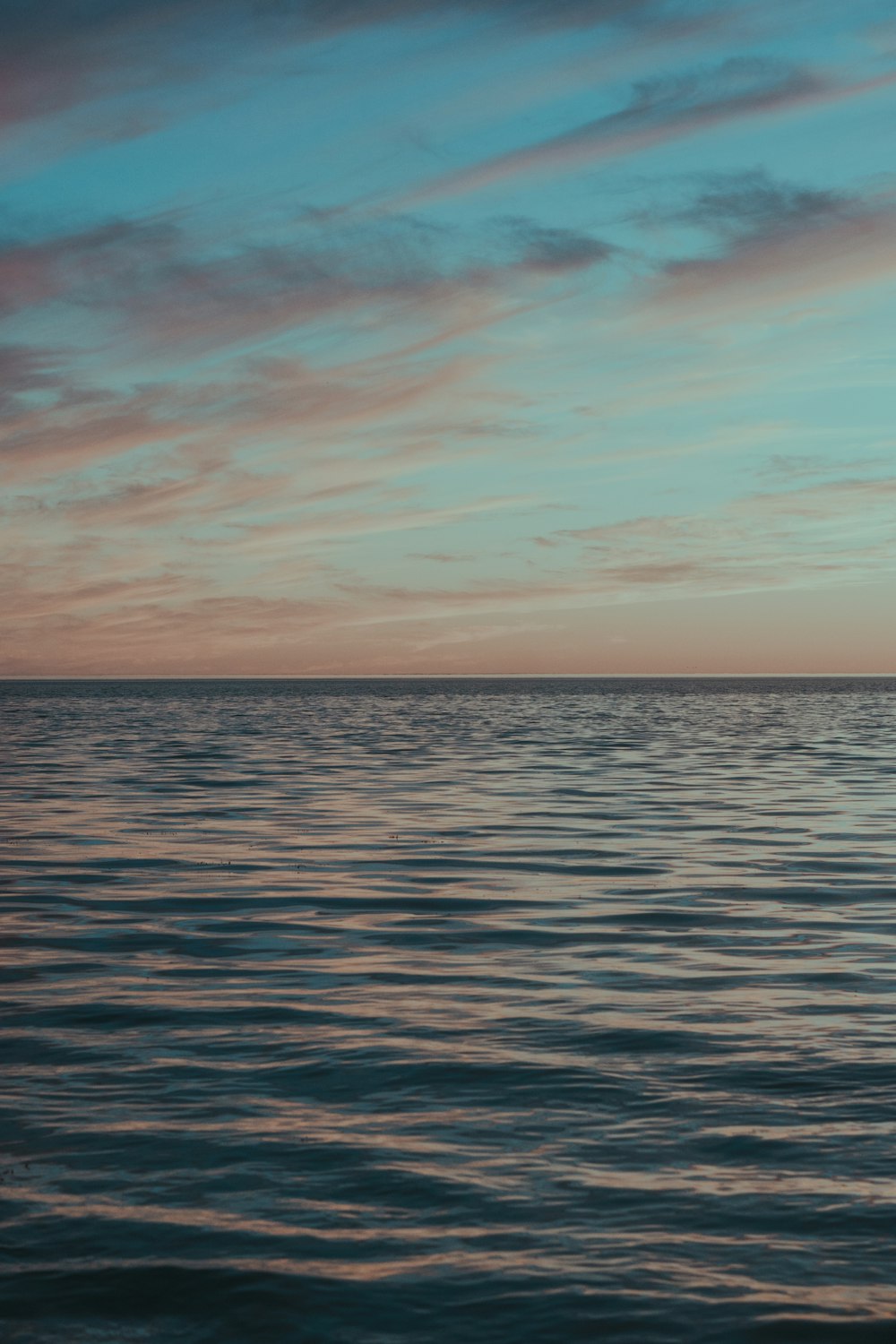 body of water under blue sky during daytime