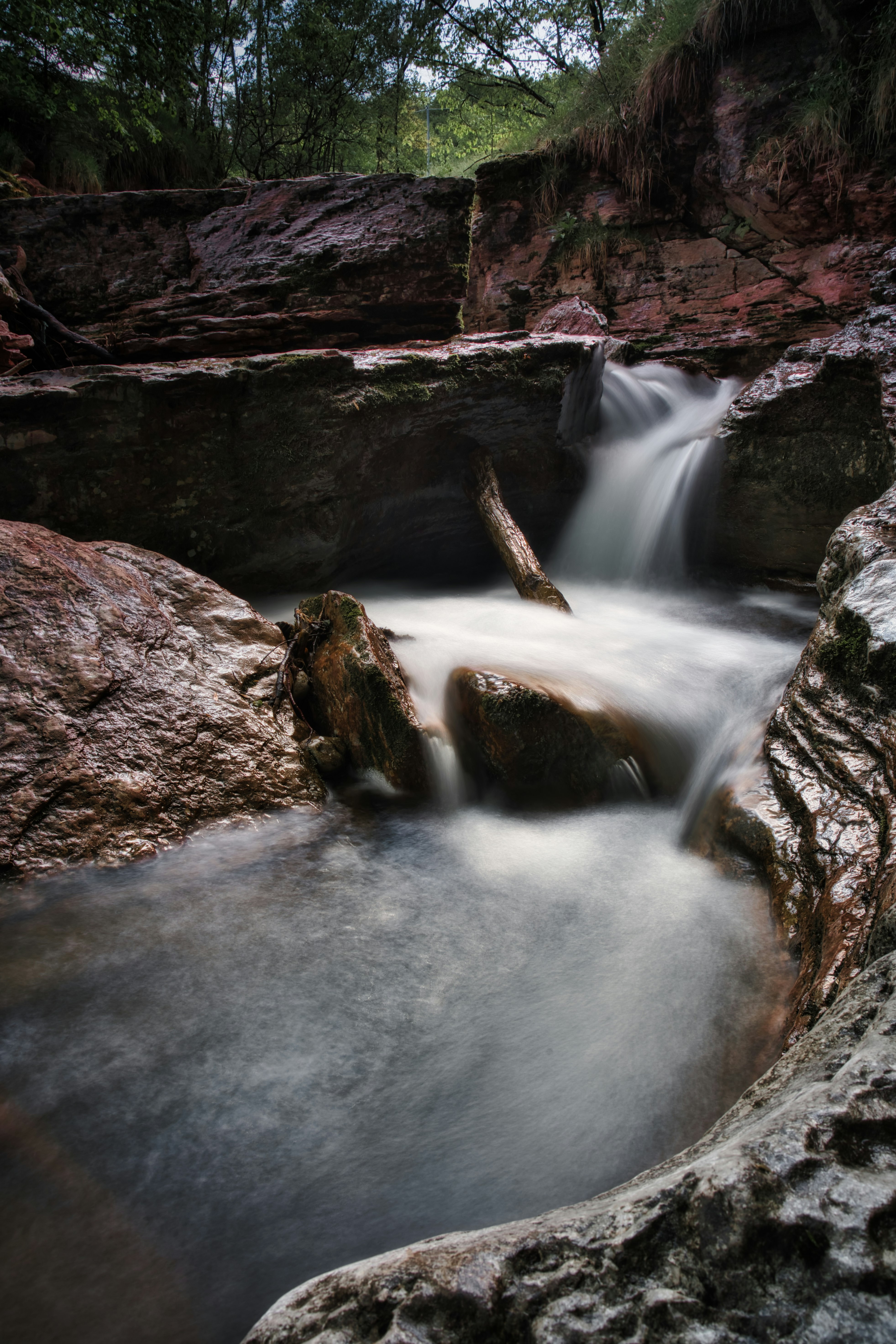 water falls in brown rocky mountain