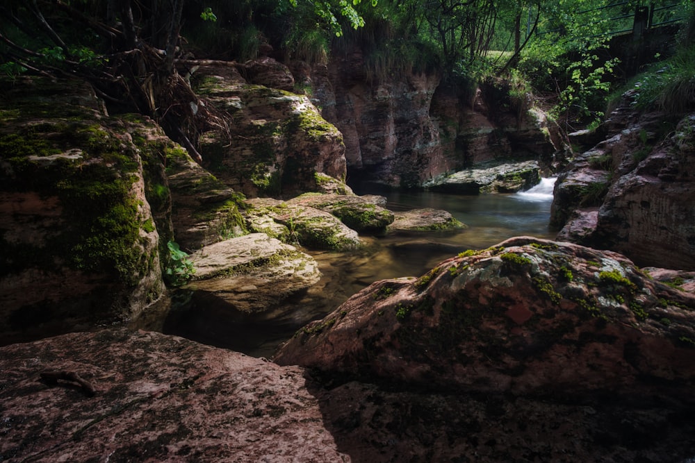 brown rock formation near river during daytime