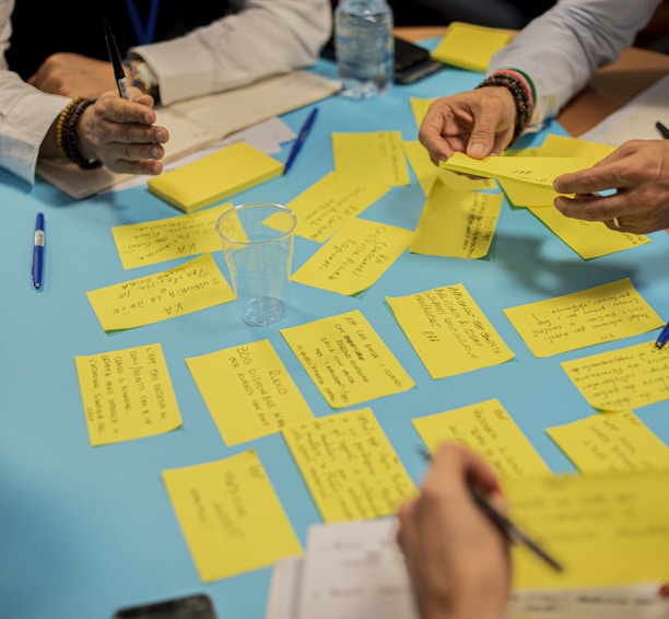 person holding yellow sticky notes