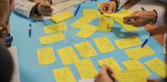 person holding yellow sticky notes