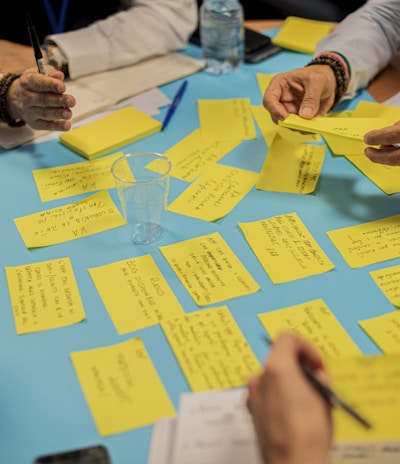 person holding yellow sticky notes