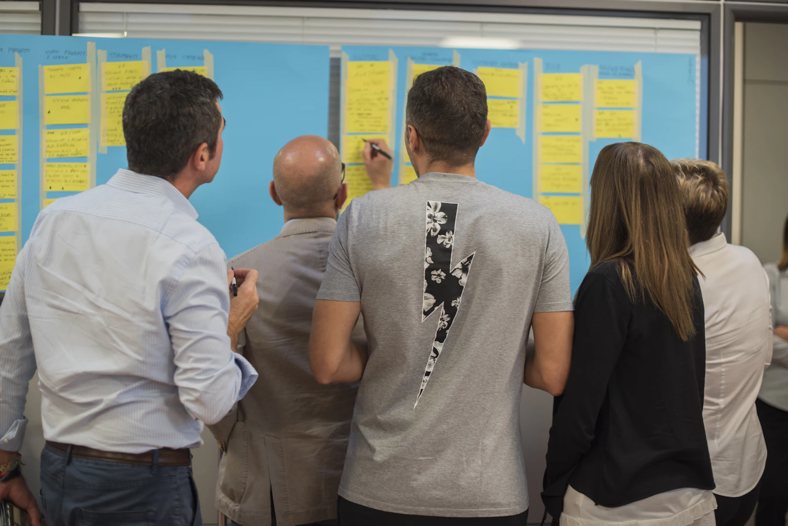 Two colleagues standing and discussing work