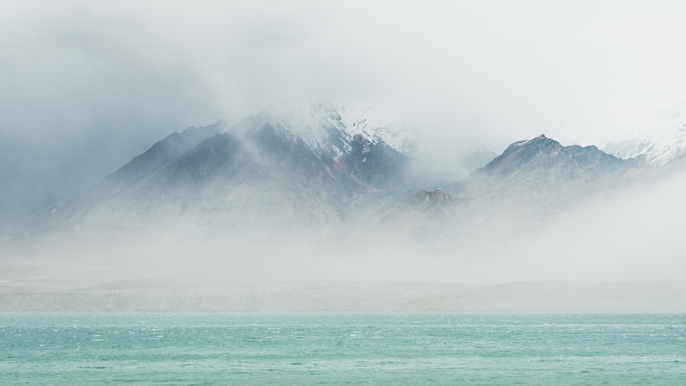 sea under white clouds during daytime