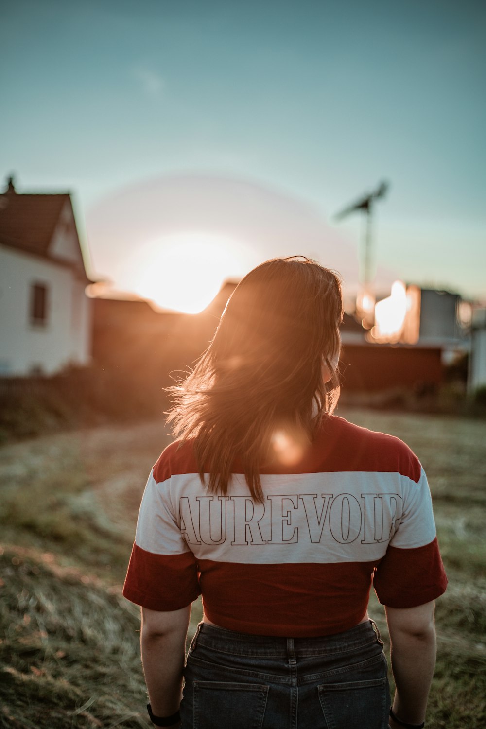 girl in white and black t-shirt standing on ground during daytime