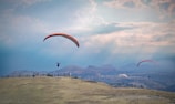 Paragliders soaring over the picturesque landscape.