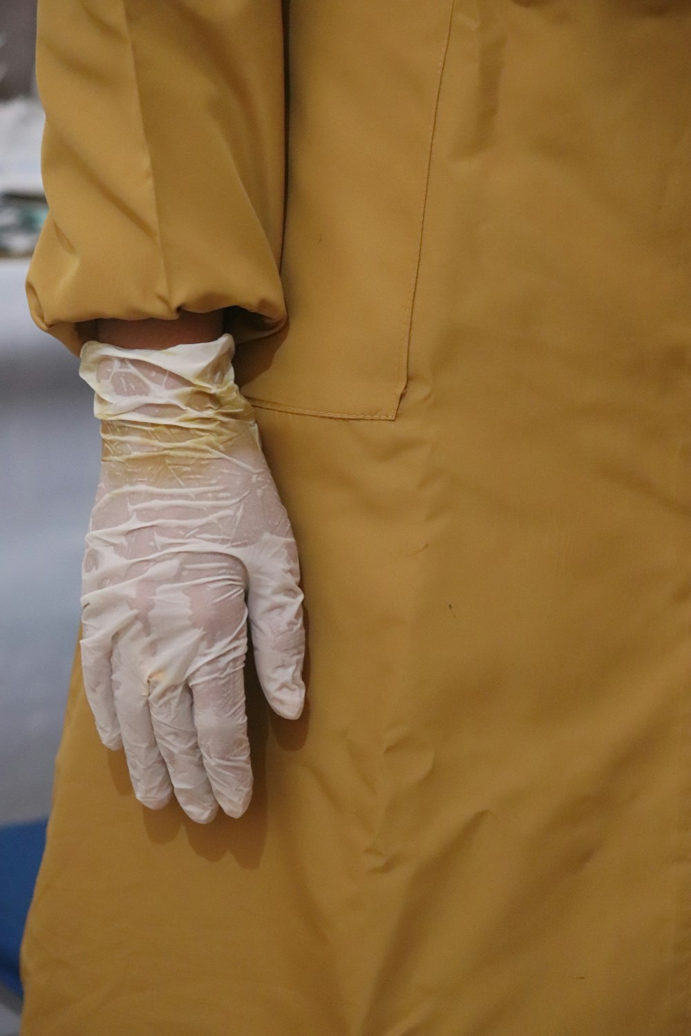 person in white pants and white gloves