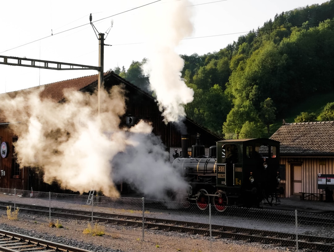 black train on rail tracks during daytime