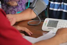a person with a blood pressure meter on a table