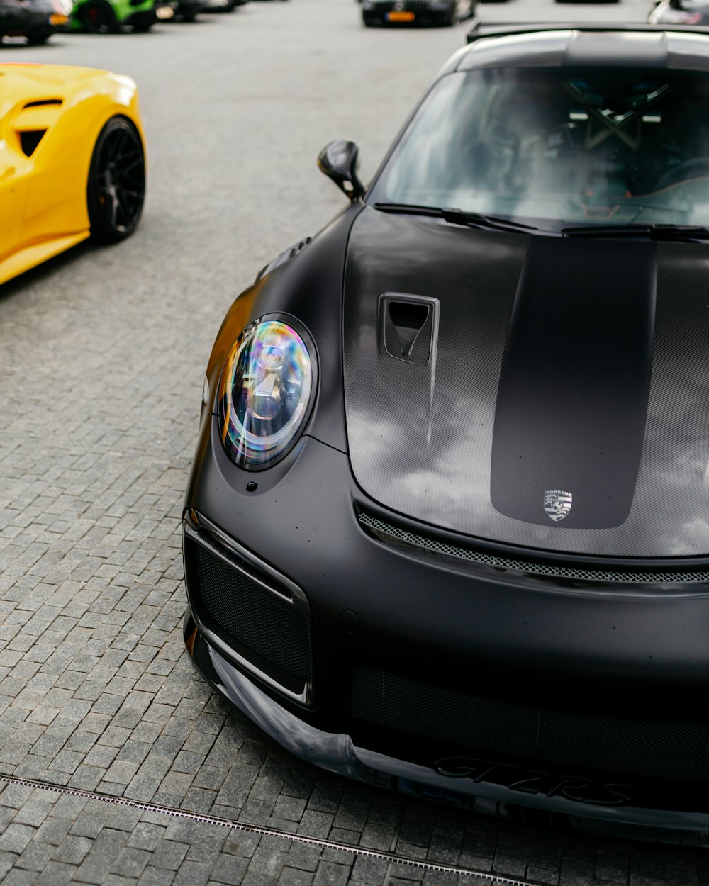 black porsche 911 parked on grey pavement during daytime