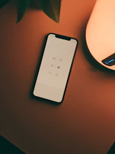 white remote control on brown wooden table