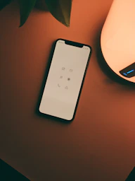 white remote control on brown wooden table