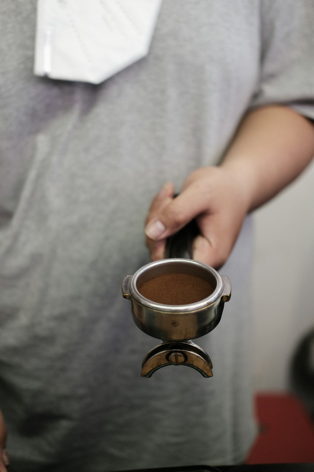 a person holding a cup of coffee in their hand