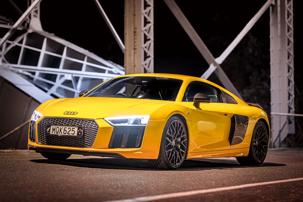 yellow lamborghini aventador parked on gray metal bridge