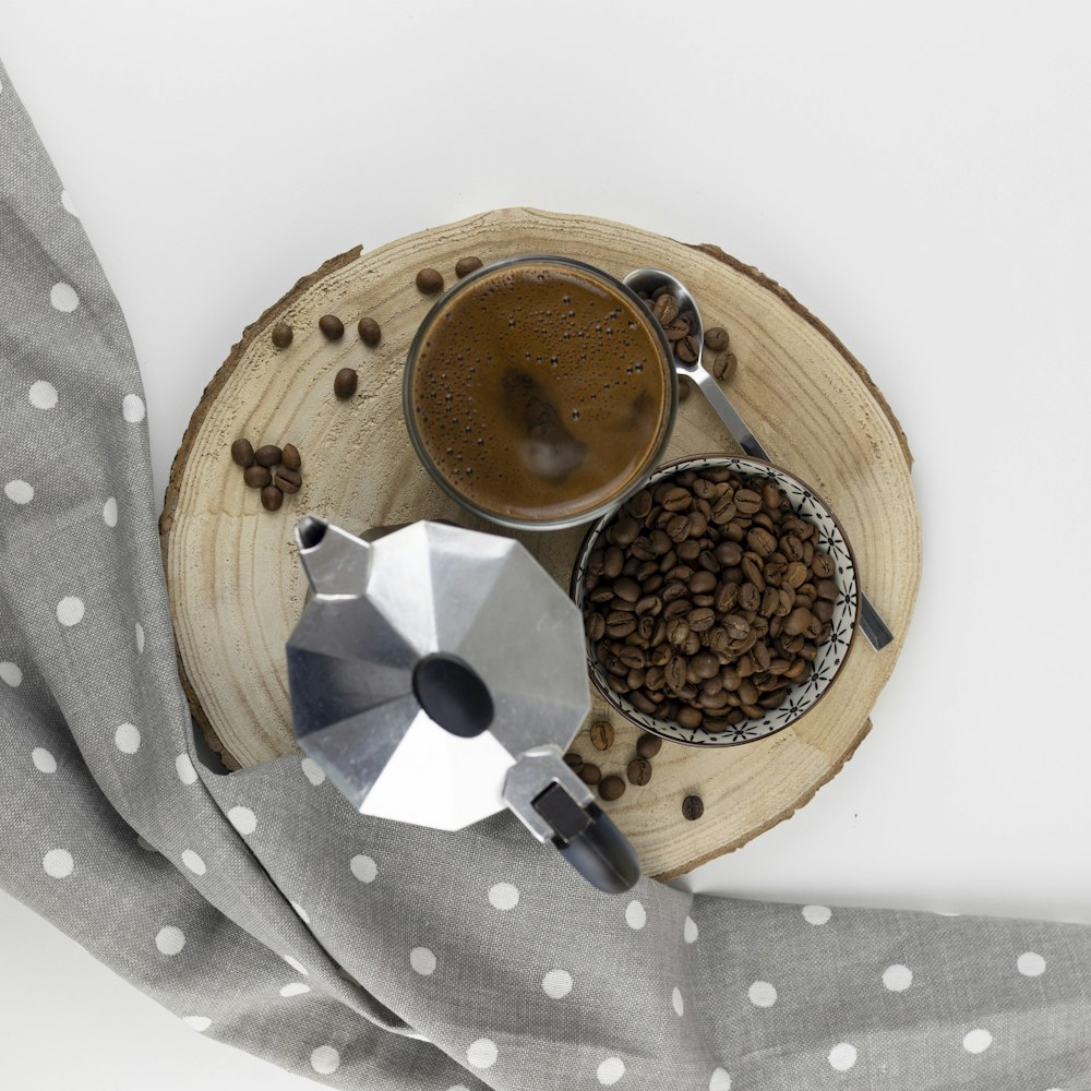 brown and black ceramic mug on brown wooden table