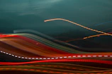 Abstract digital art featuring flowing light trails and holographic textures.