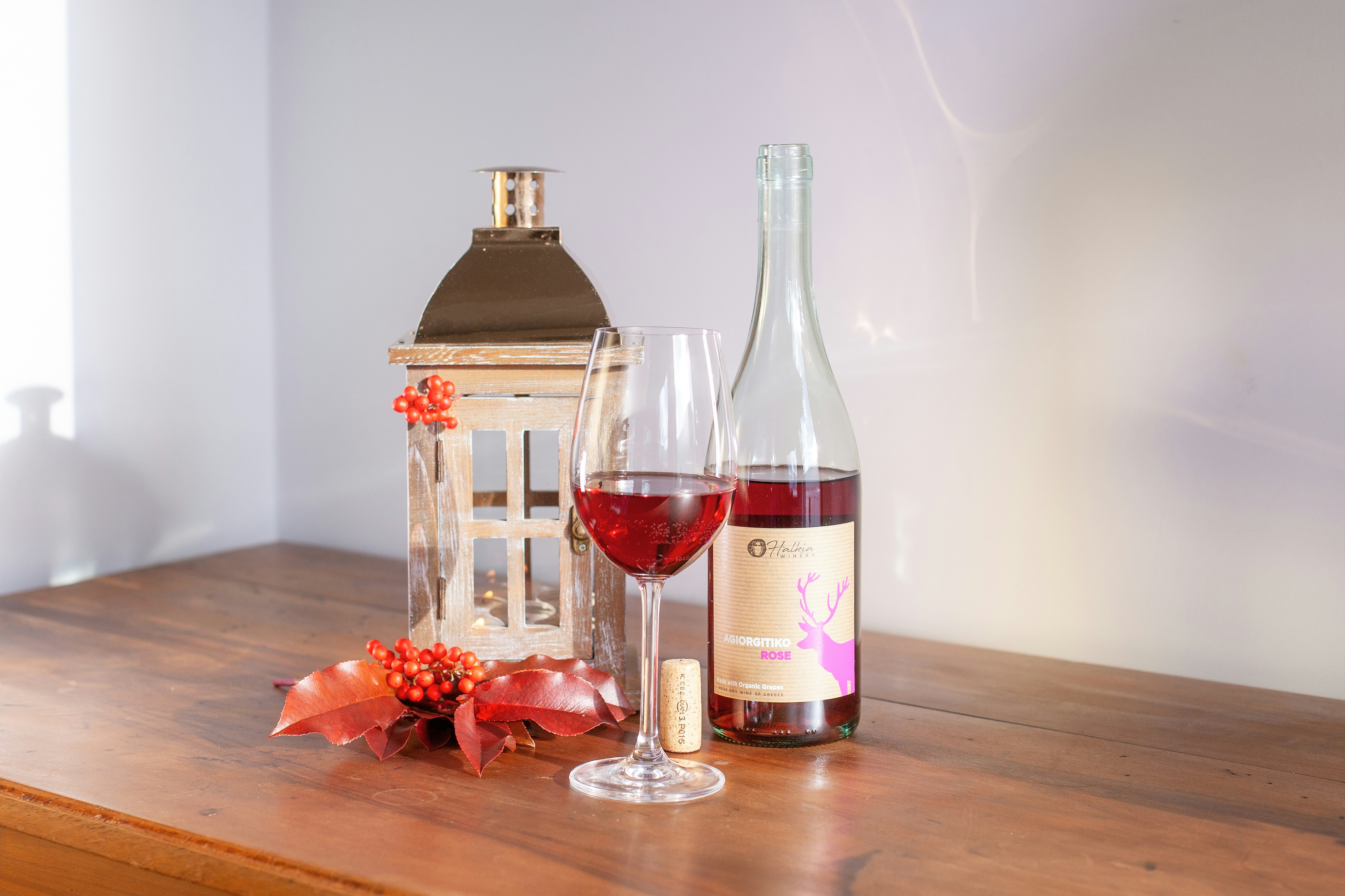 Rose wine bottle and glass with a lantern