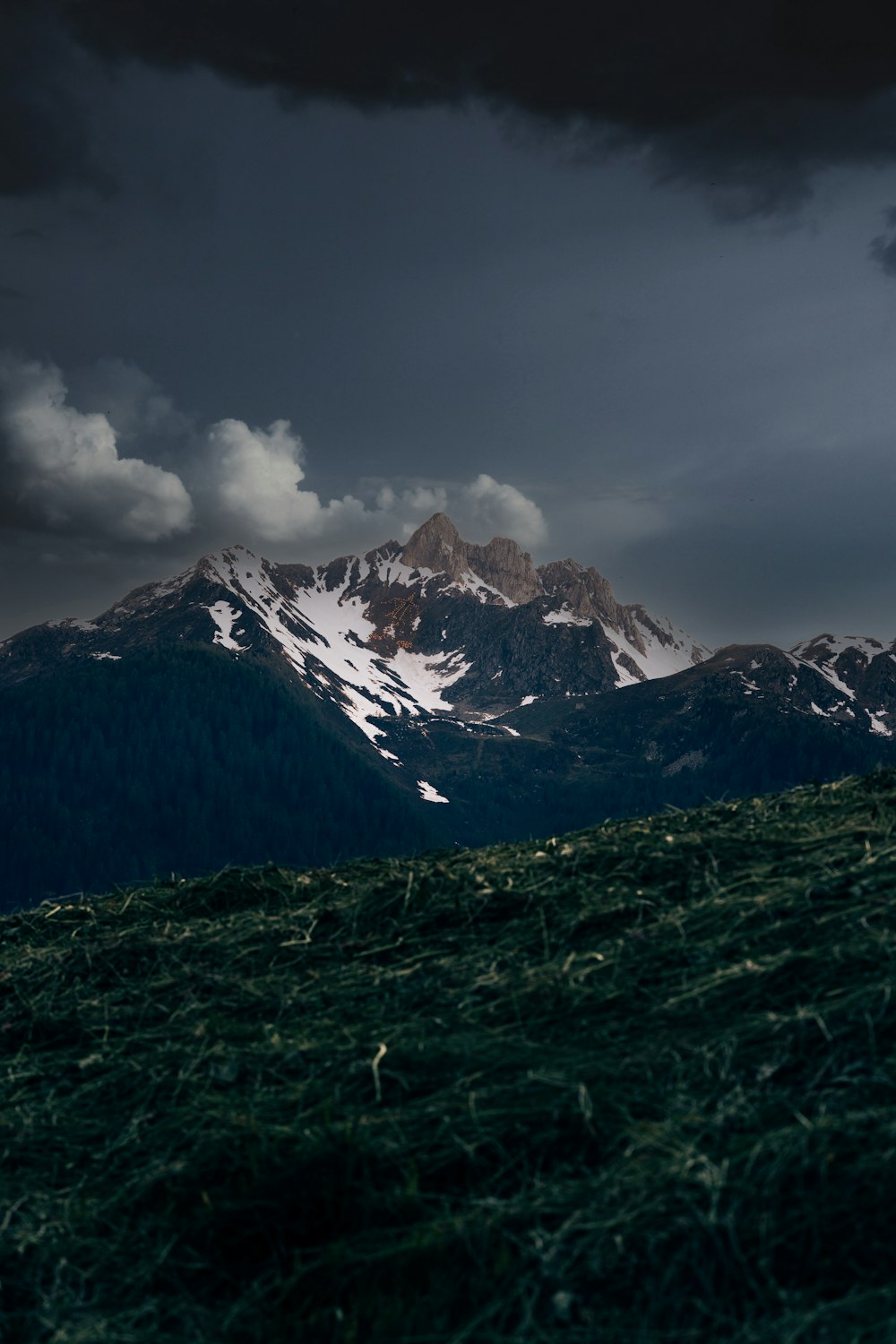 snow covered mountain under cloudy sky during daytime