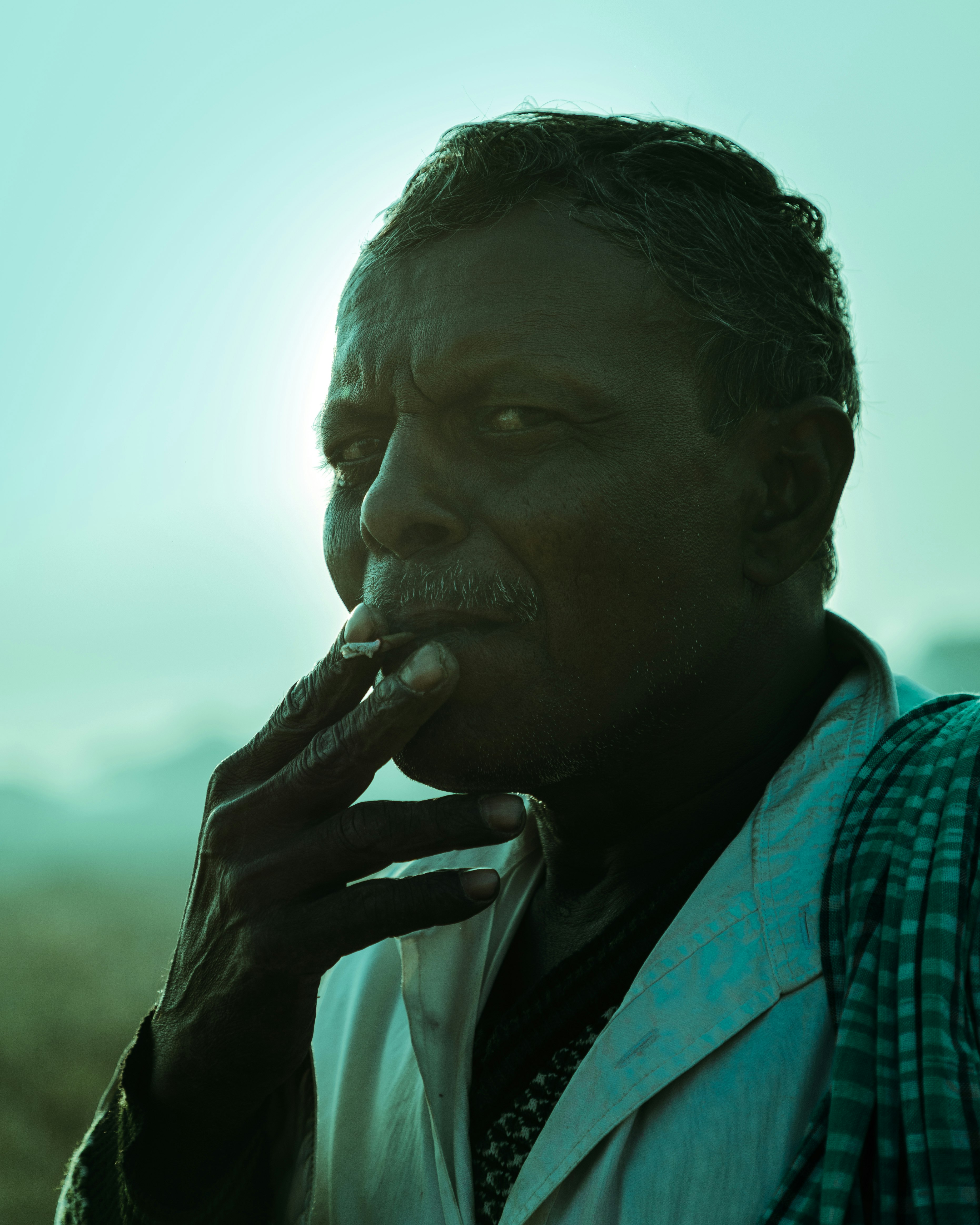 An Indian farmer taking a smoke break from his daily work. 