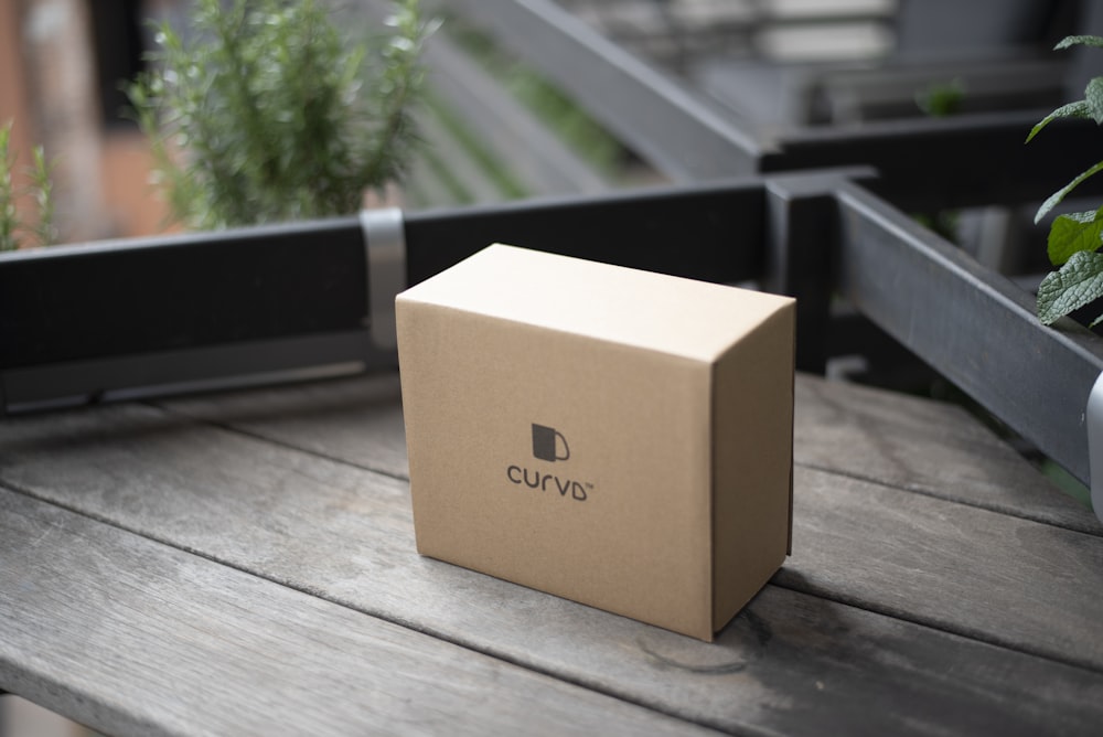 brown cardboard box on brown wooden table