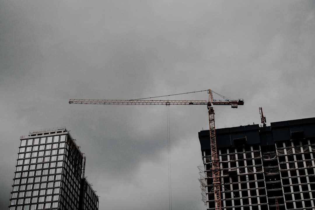 orange crane near building during daytime