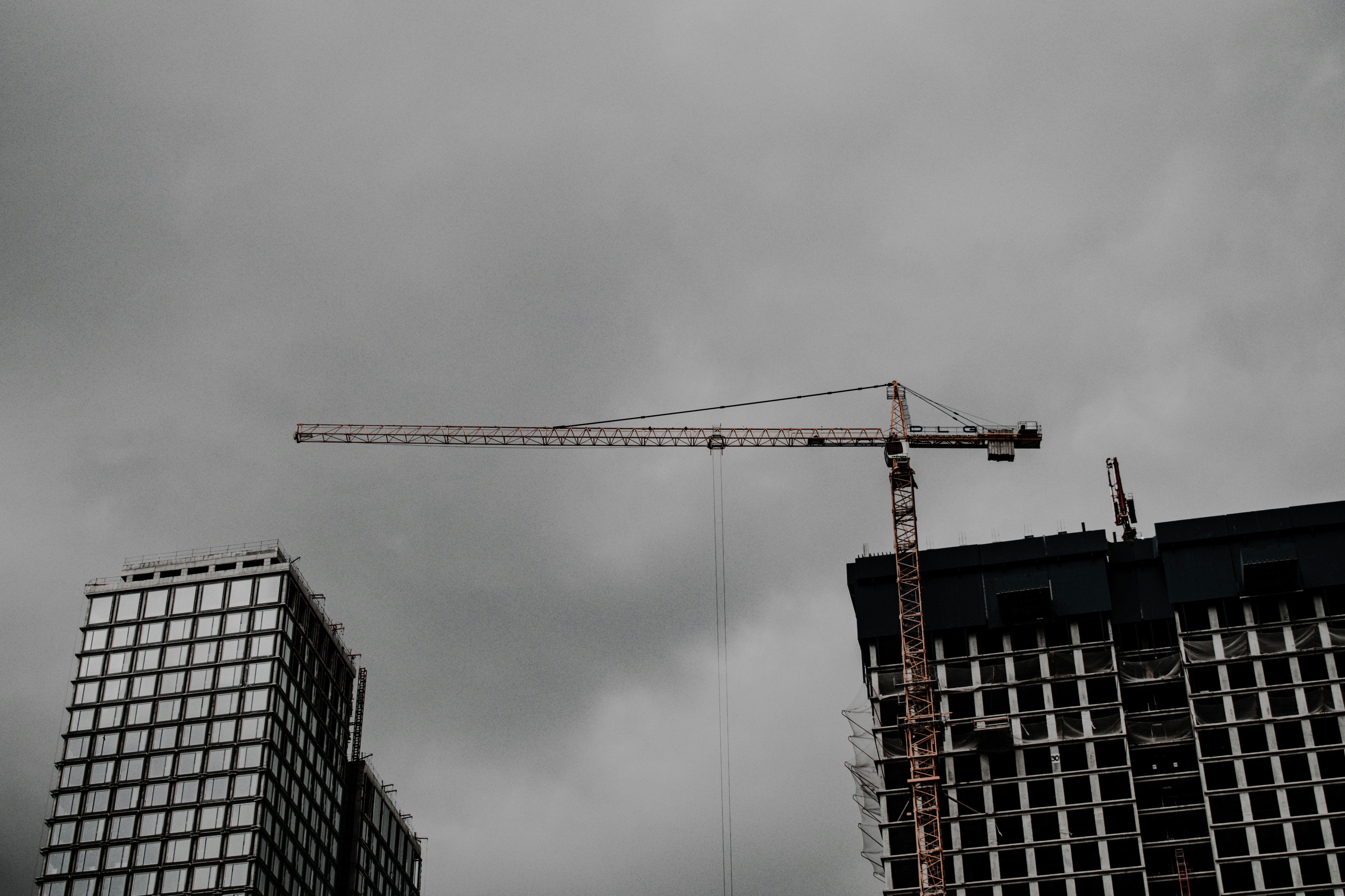 orange crane near building during daytime