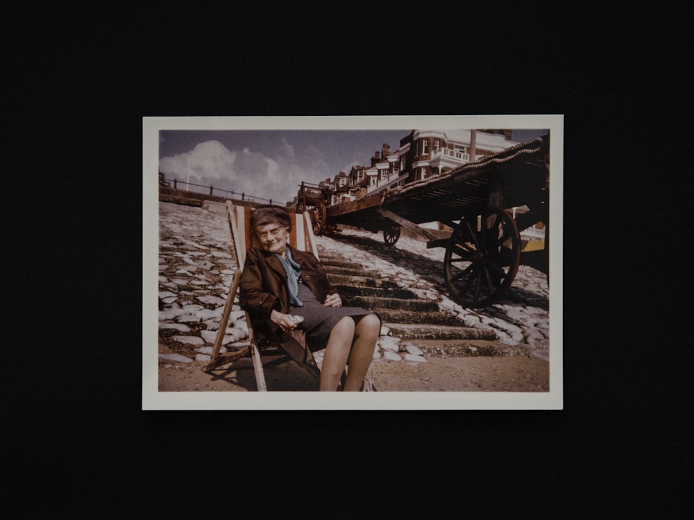 woman in white shirt sitting on brown wooden chair