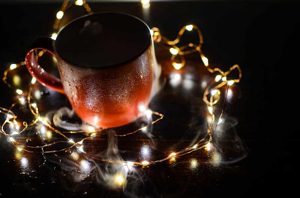 clear glass mug with brown liquid