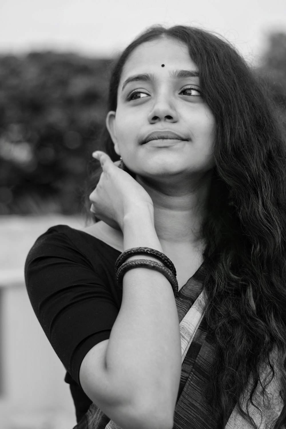 woman in black cardigan wearing silver watch