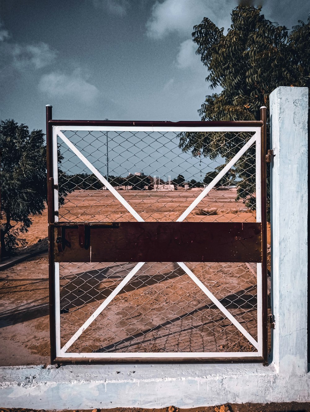brown wooden frame with white metal fence