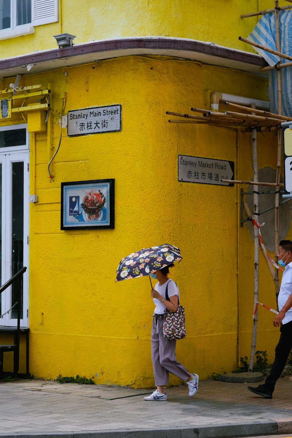 woman in white and black polka dot dress holding umbrella