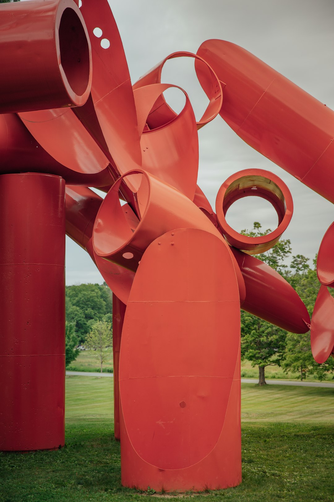 red metal pipe near green grass field during daytime