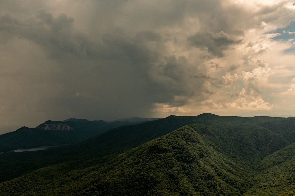 green mountain under white clouds during daytime