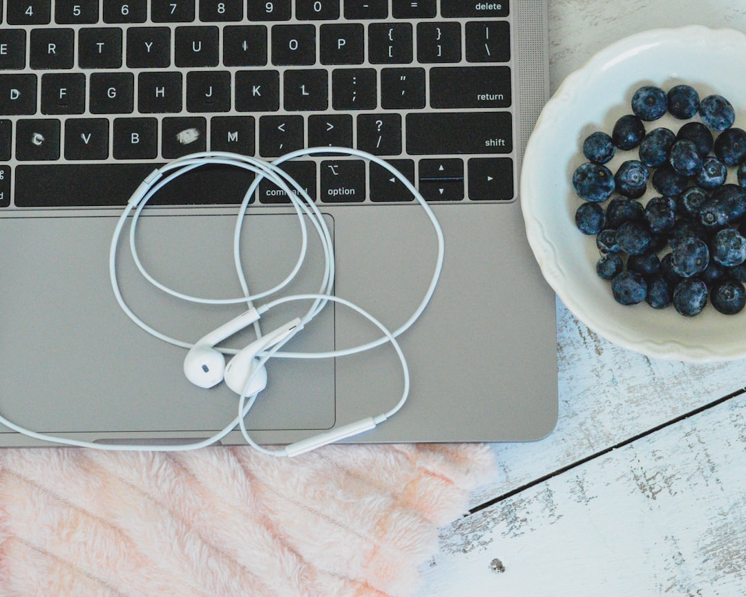 white earbuds on silver macbook
