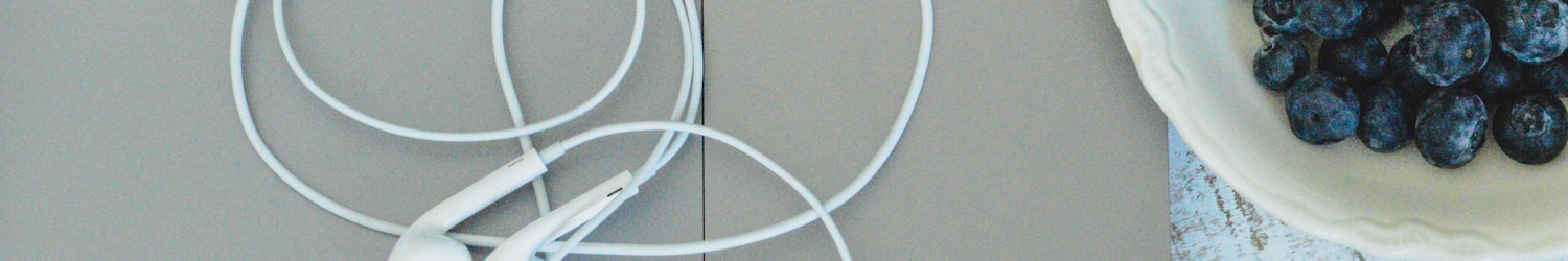 white earbuds on silver macbook