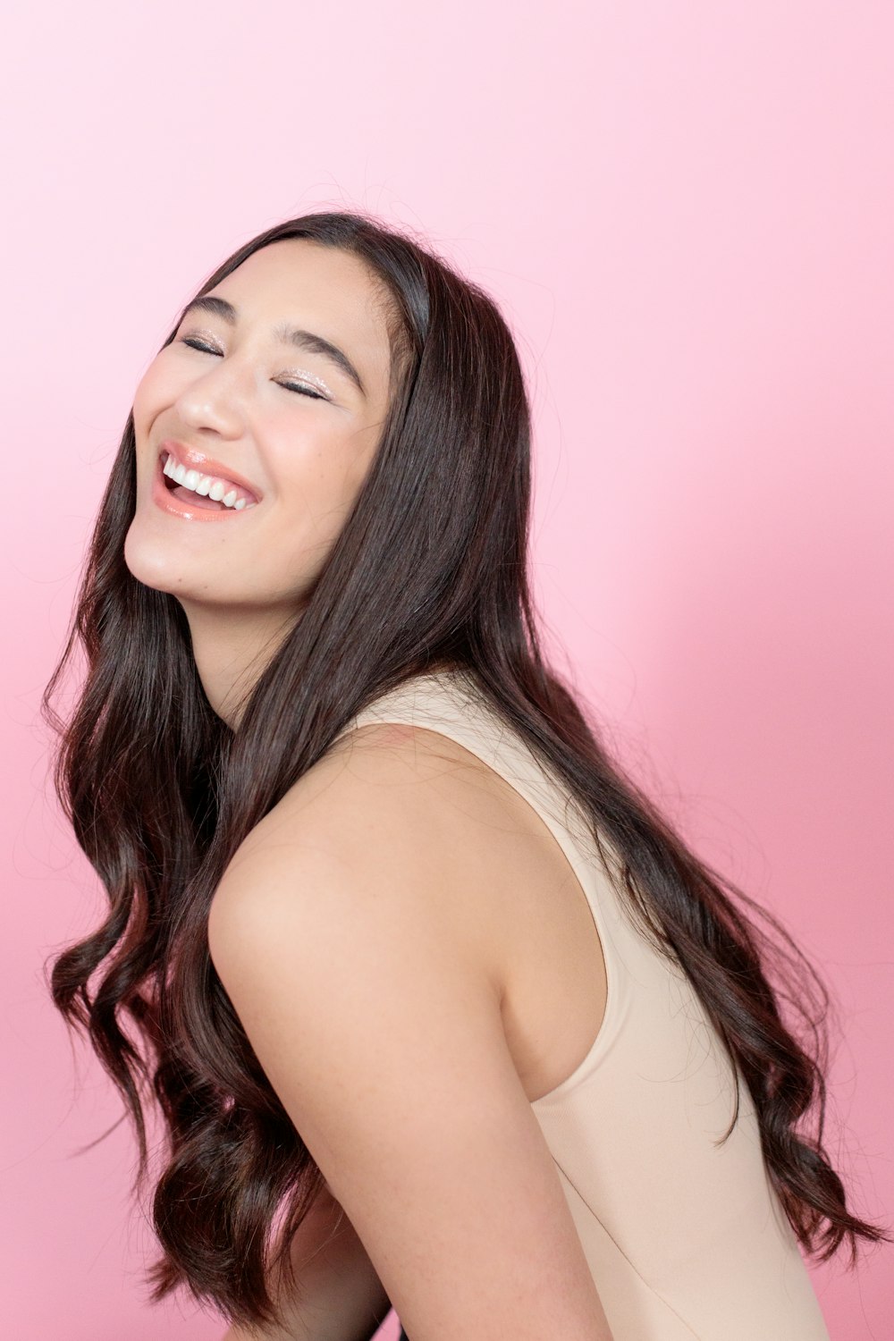 woman in white tank top smiling