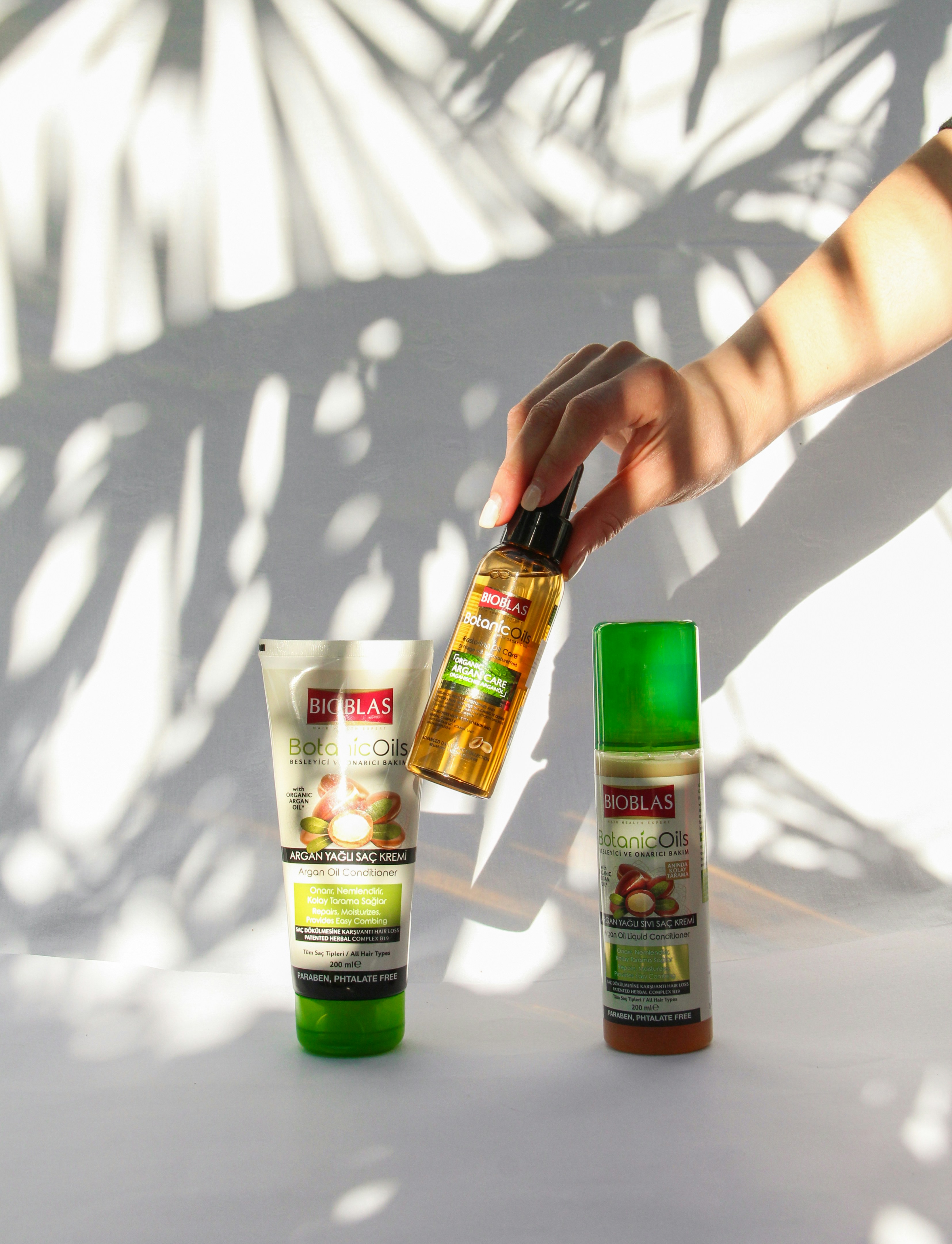 person holding green and yellow labeled bottle