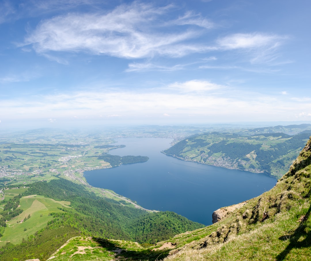 aerial view of green mountains and lake during daytime