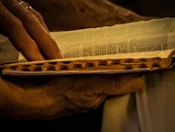 Close-up of hands flipping through the pages of a vintage novel.