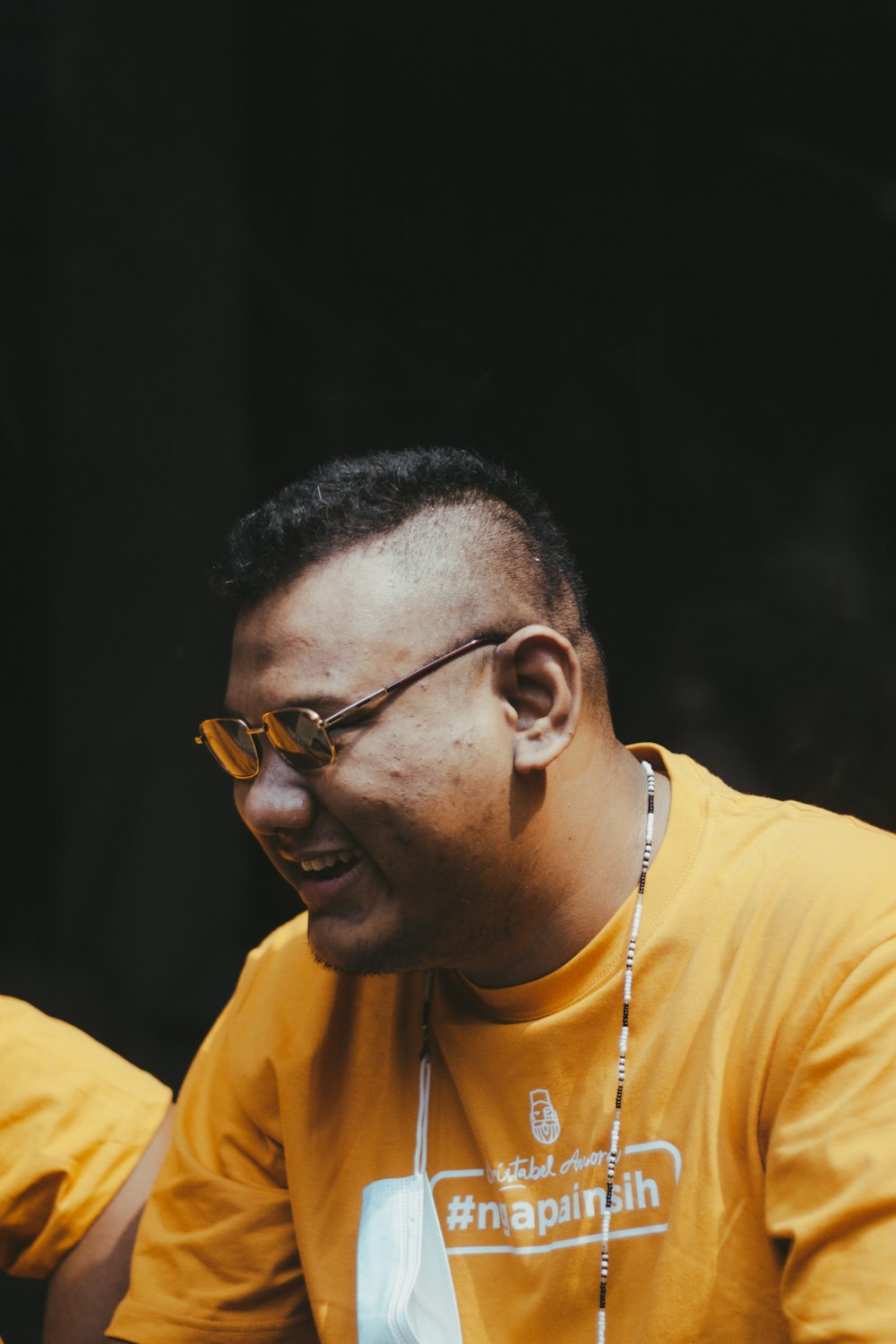 man in yellow crew neck shirt wearing black framed eyeglasses