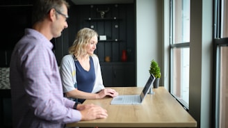 woman in blue and white shirt sitting beside woman in blue shirt