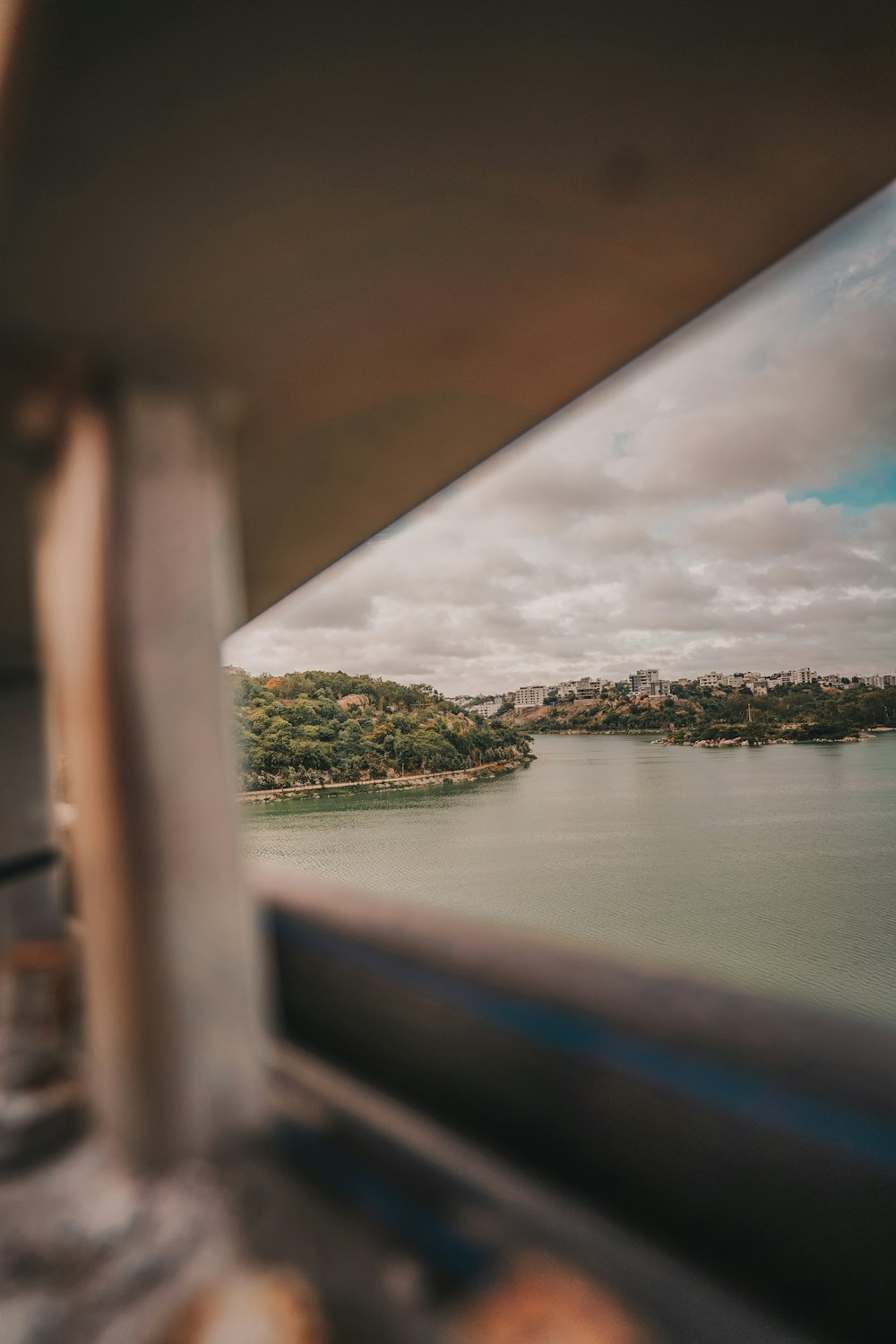 green island on body of water under cloudy sky during daytime