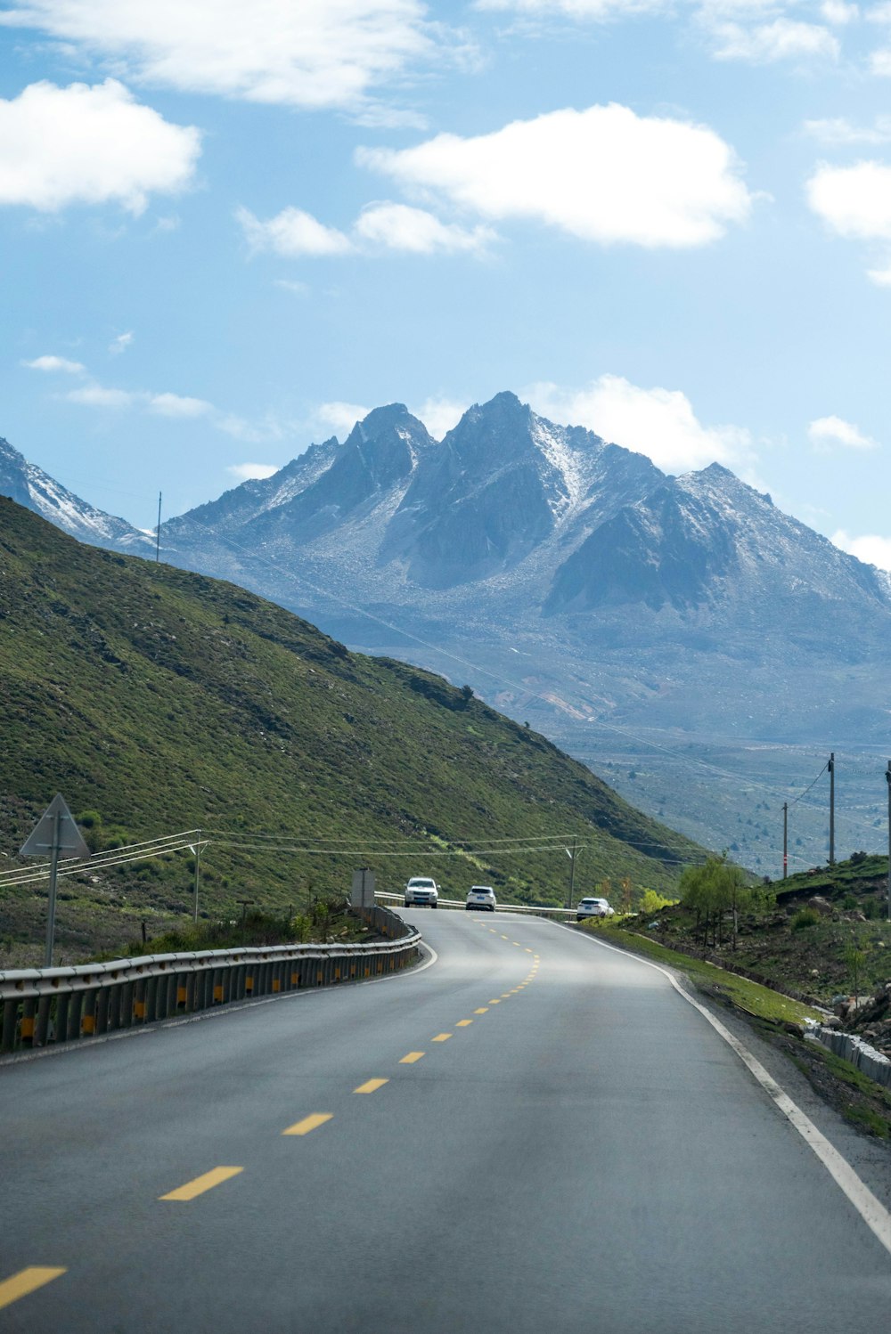 black car on road near mountain during daytime